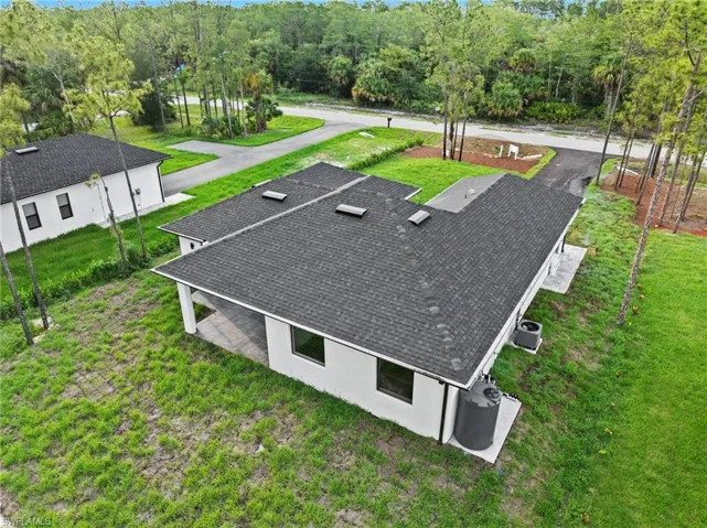 View of subject property with a heavily wooded area
