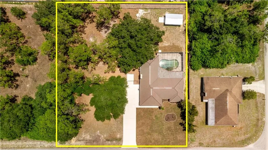 Aerial view showcasing the 1 acre property with large storage shed
