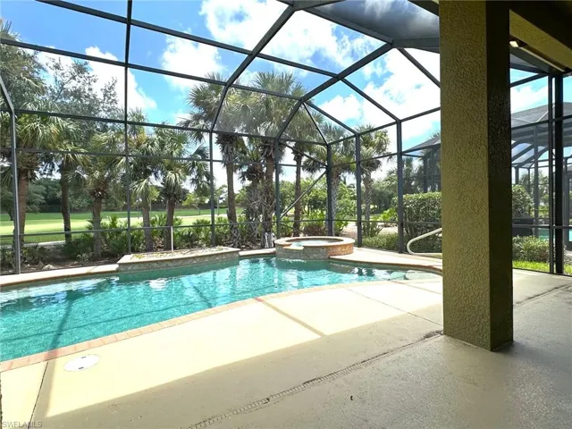 Screened pool area with spa.