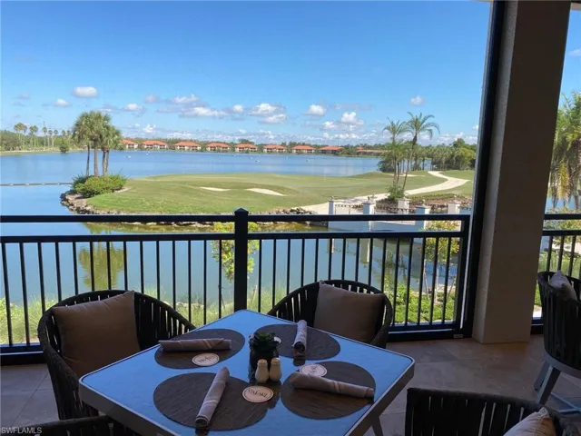 Screened balcony featuring a water view
