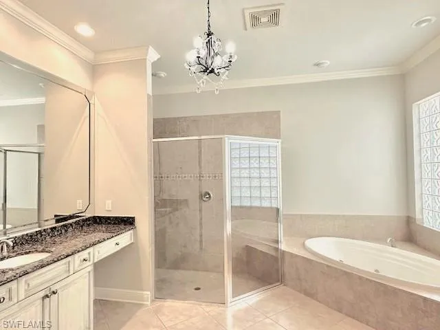 Bathroom with large oversized tub and separate shower and twin vanities.