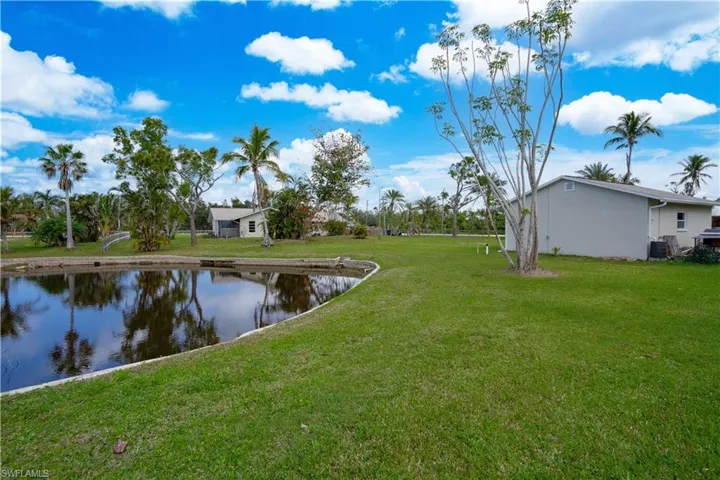 View of yard with a water view and cooling unit