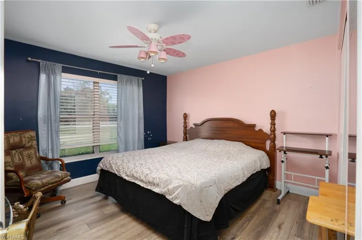 Bedroom with hardwood / wood-style flooring and ceiling fan