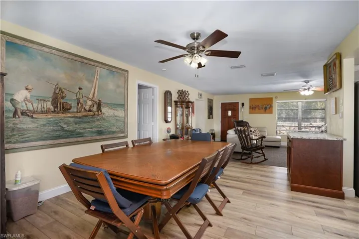 Dining area with ceiling fan and light hardwood / wood-style flooring