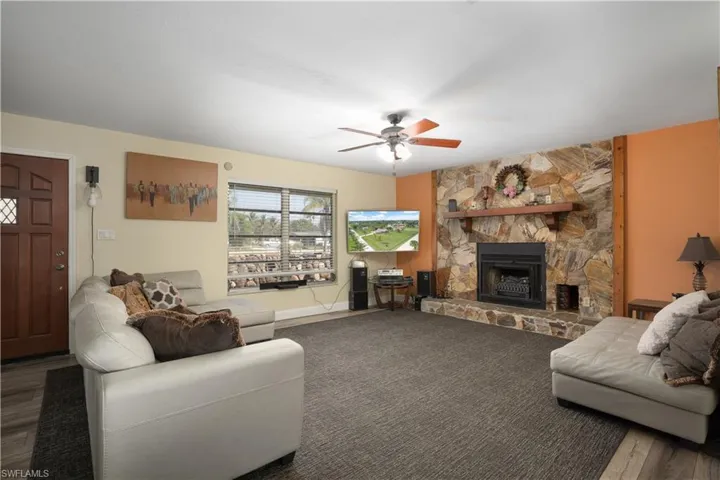 Living room with ceiling fan and a fireplace