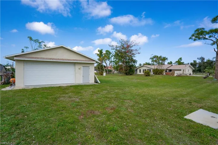 View of yard featuring an outbuilding and a garage