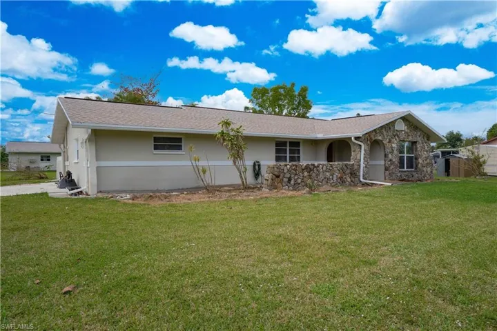 Back of house featuring a yard