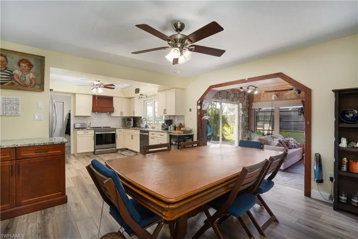 Dining room featuring ceiling fan, sink, and light hardwood / wood-style floors