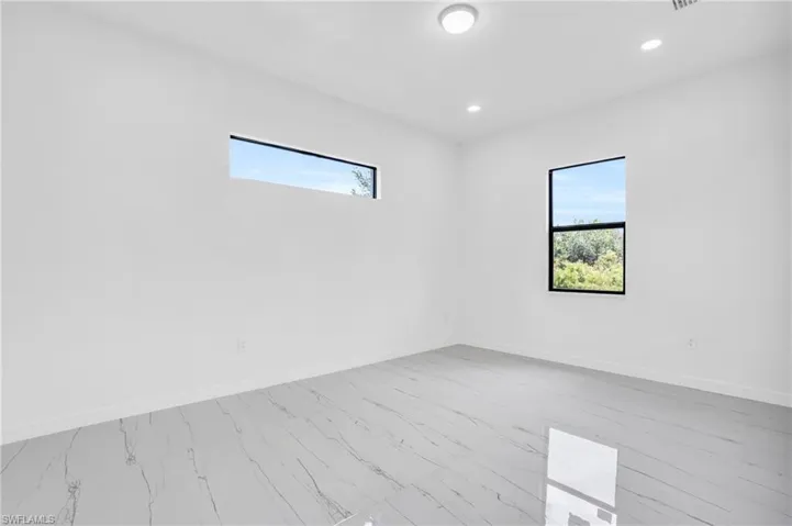 Empty room with light hardwood / wood-style floors