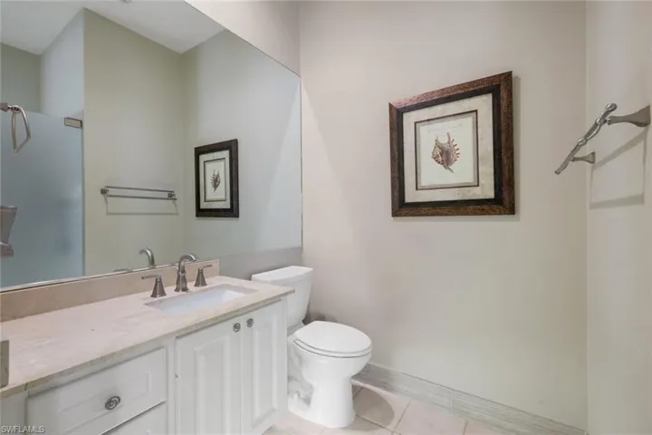Bright room featuring a window with privacy blinds, neutral wall tones, a ceiling fan, and carpeted flooring