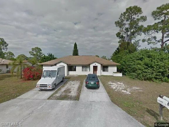 Single story home with concrete driveway