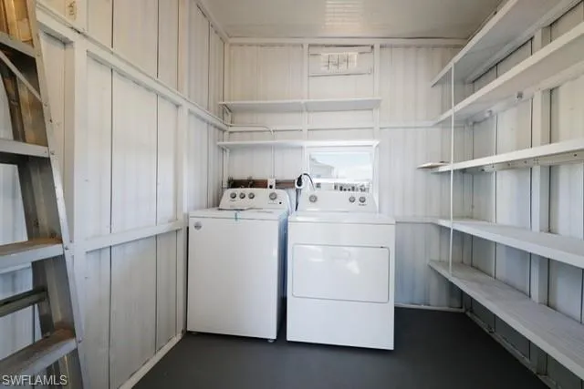 Laundry room featuring separate washer and dryer and concrete flooring