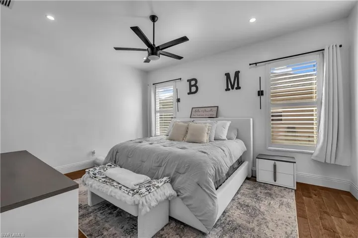 Bedroom with dark wood finished floors, recessed lighting, and a ceiling fan