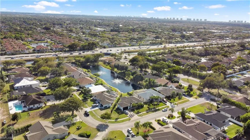 Aerial view of property's location featuring nearby suburban area and skyline