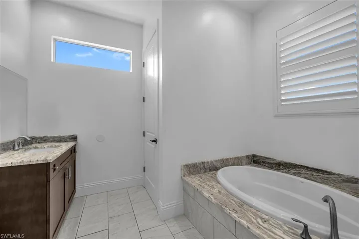 Bathroom featuring vanity and a bath