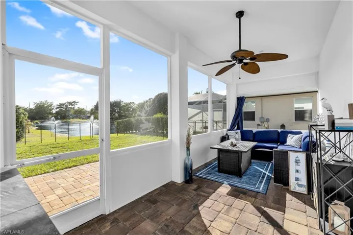 Sunroom featuring outdoor lounge area, a water view, and ceiling fan