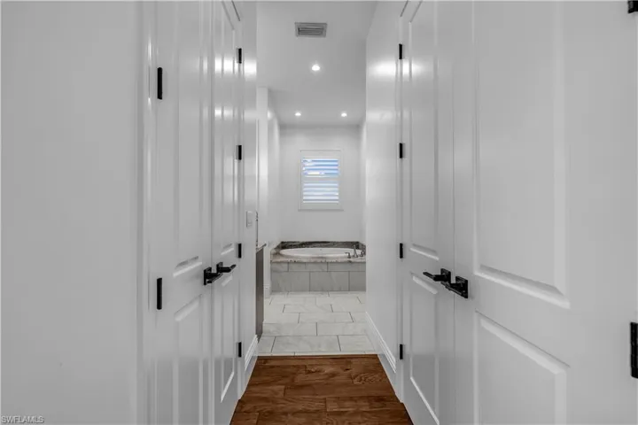 Hall with recessed lighting and dark wood-type flooring