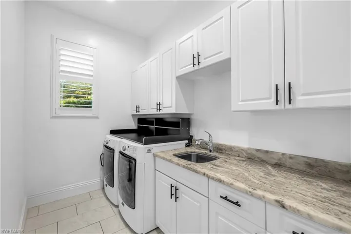 Laundry area featuring cabinet space and washing machine and dryer
