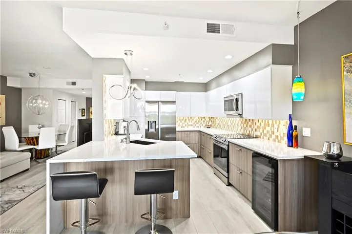 Re-designed kitchen island that is squared off with a quartz waterfall. Both functional and visually appealing.