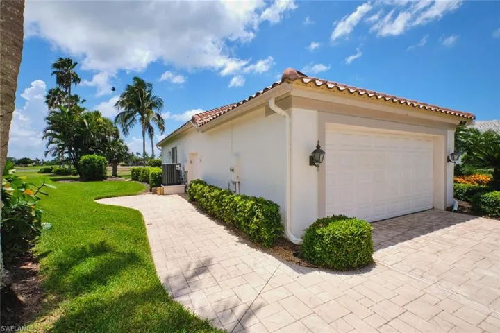Back of house featuring stucco siding, a lawn, an outdoor pool, and a tiled roof