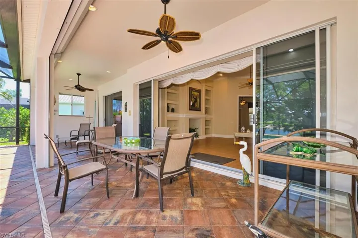 Bedroom with access to exterior, carpet floors, and a ceiling fan