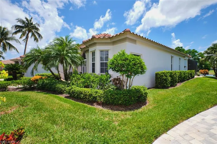 Property entrance featuring a tiled roof, stucco siding, and an attached garage