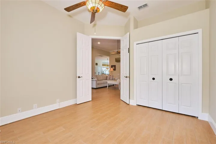 Living area featuring ceiling fan, light tile patterned flooring, and recessed lighting