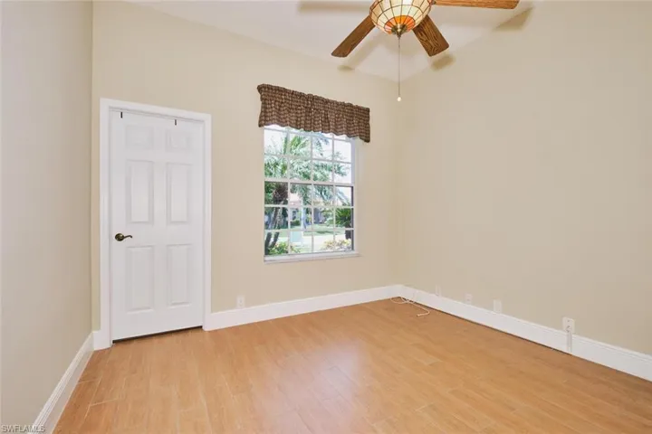Living room featuring ceiling fan and light tile patterned flooring