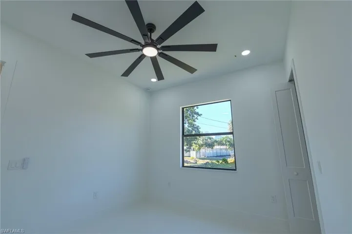 Empty room featuring ceiling fan and recessed lighting
