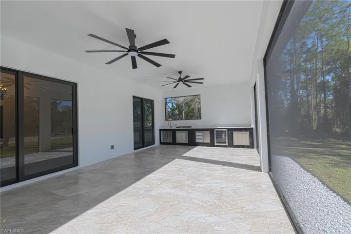 Unfurnished sunroom featuring beverage cooler