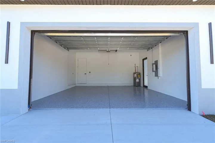 Garage with electric water heater and electric panel