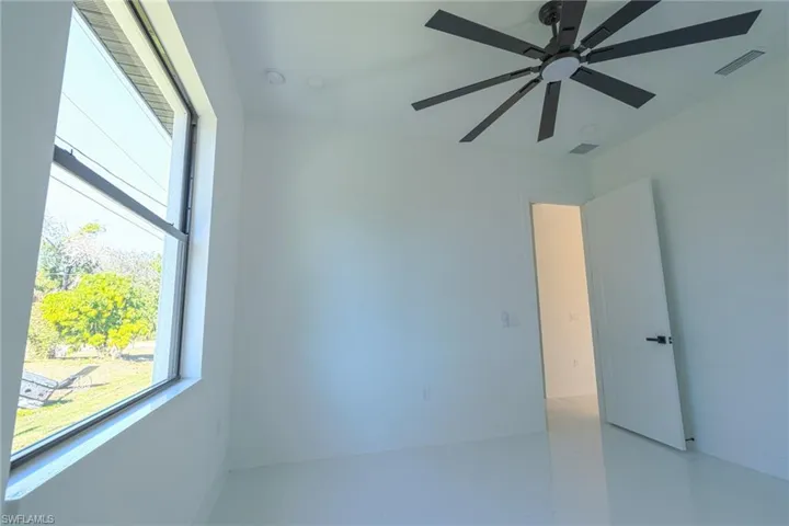 Spare room with ceiling fan and light tile patterned flooring