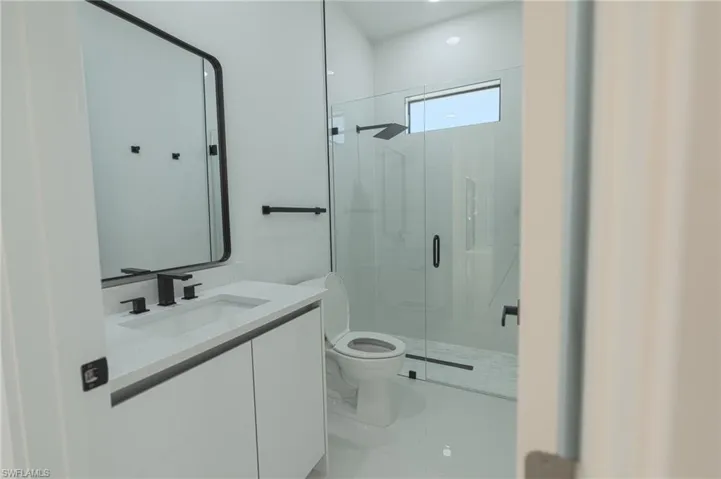 Full bathroom featuring a stall shower and vanity