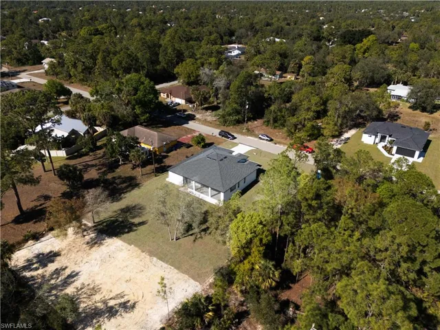 Aerial overview of property's location with a heavily wooded area