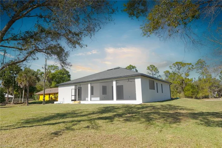 Back of house featuring a patio area, a yard, and ceiling fan