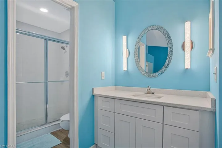Full bathroom featuring a stall shower and vanity