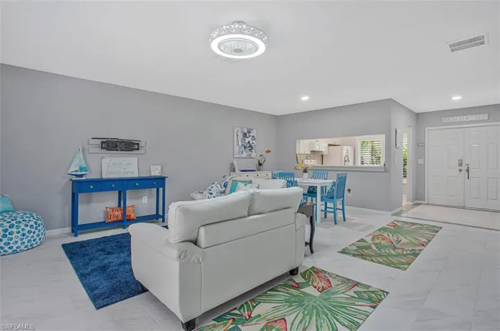 Living room featuring baseboards and recessed lighting
