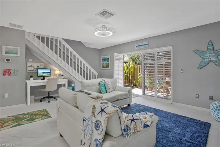 Living room with a desk and stairway