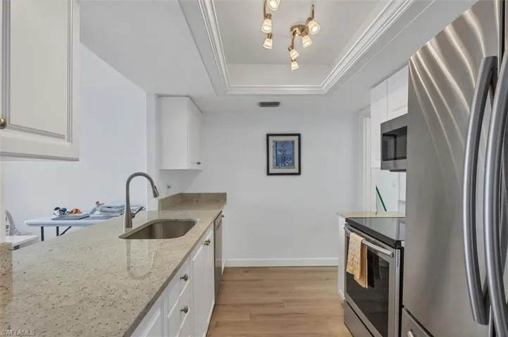 Upgraded kitchen with granite countertops and tray ceiling.