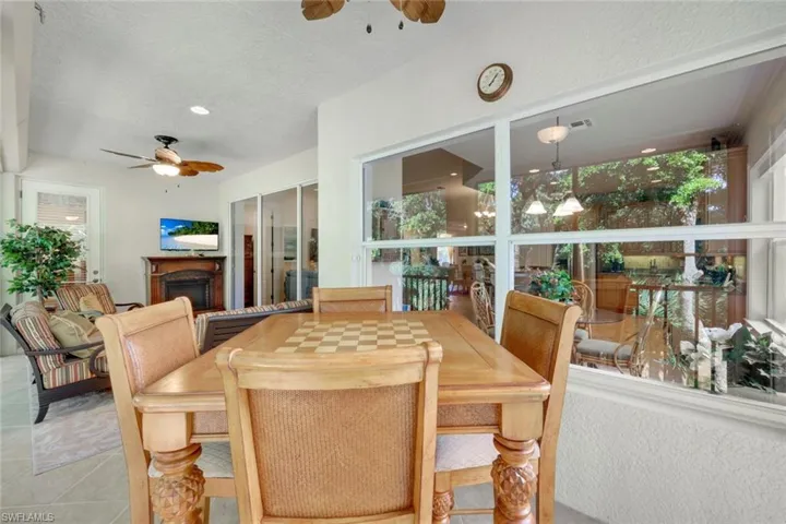 Tiled dining area featuring ceiling fan, a textured ceiling, and a wealth of natural light