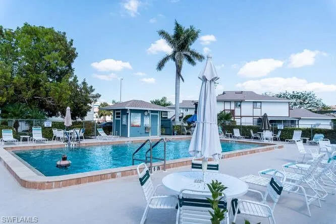View of swimming pool featuring an outdoor structure and a patio