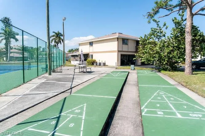 View of home's community with tennis court