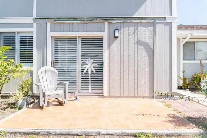 Doorway to property featuring a patio