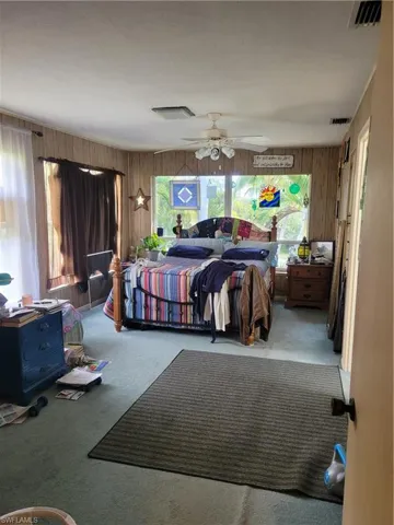 Large master bedroom with lots of windows overlooking the private yard. There is a small balcany off the master bedroom.