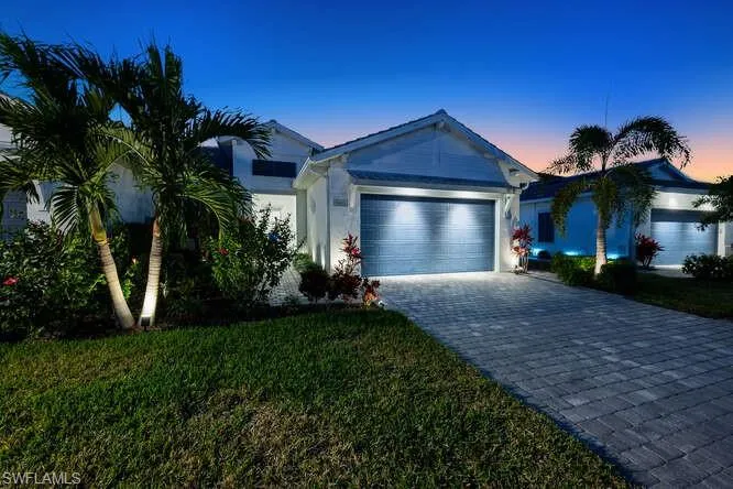 Ranch-style house featuring a yard and a garage