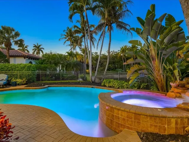 Relaxing heated pool / spa featuring a fenced backyard and a patio