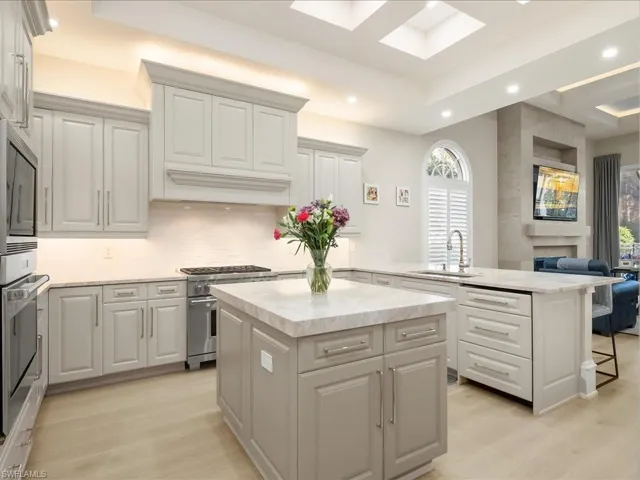 Light, bright gourmet kitchen with Sub-zero, Wolff, and Bosch appliances.  Dual refrigerater drawers, icemaker and leathered Taj Mahal quartzite countertops provide a luxurious feel.