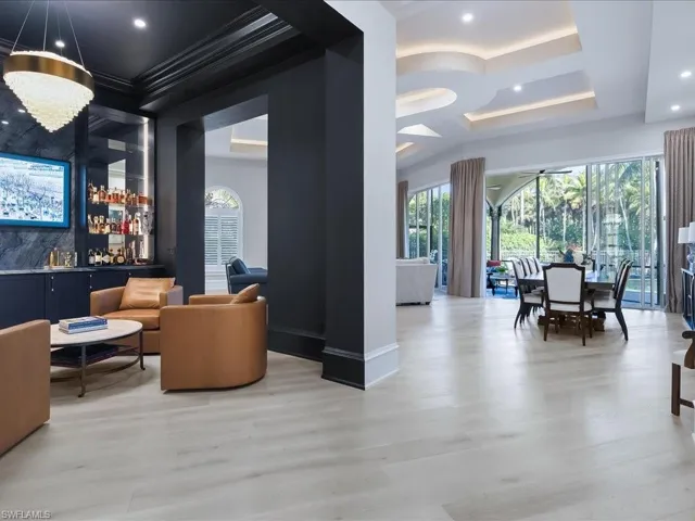 Custom bar/cocktails room with dramatic lighting, icemaker and wine refrigerator.