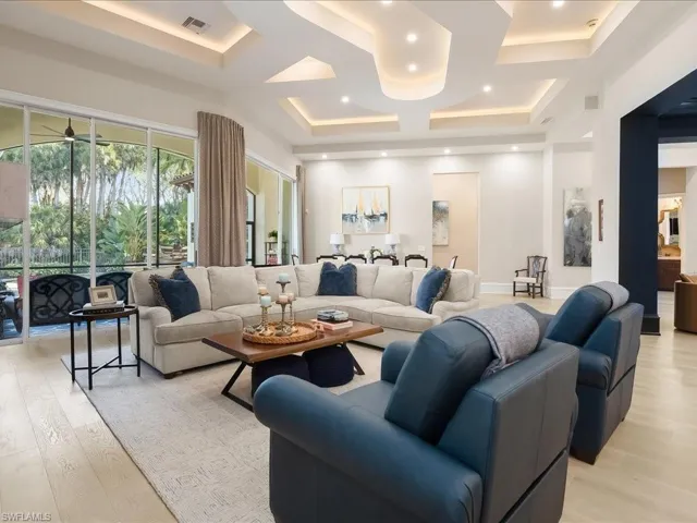 Living area featuring European White Oak wood flooring, and dramatic ceiling details.