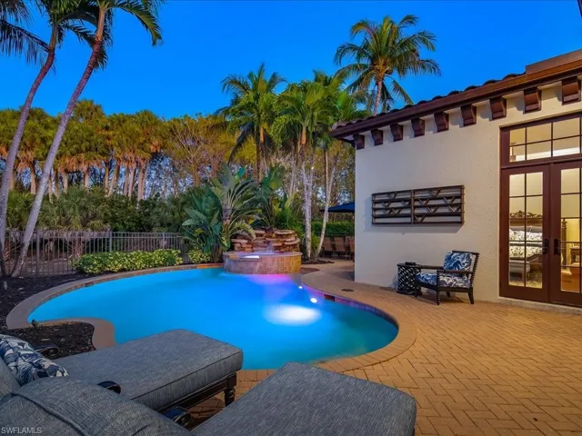 Heated pool and spa with large patio, dining area and lounge chairs.